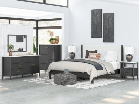 Cadmori King Upholstered Panel Bed with Mirrored Dresser, Chest and 2 Nightstands in Black/White - PKG020277