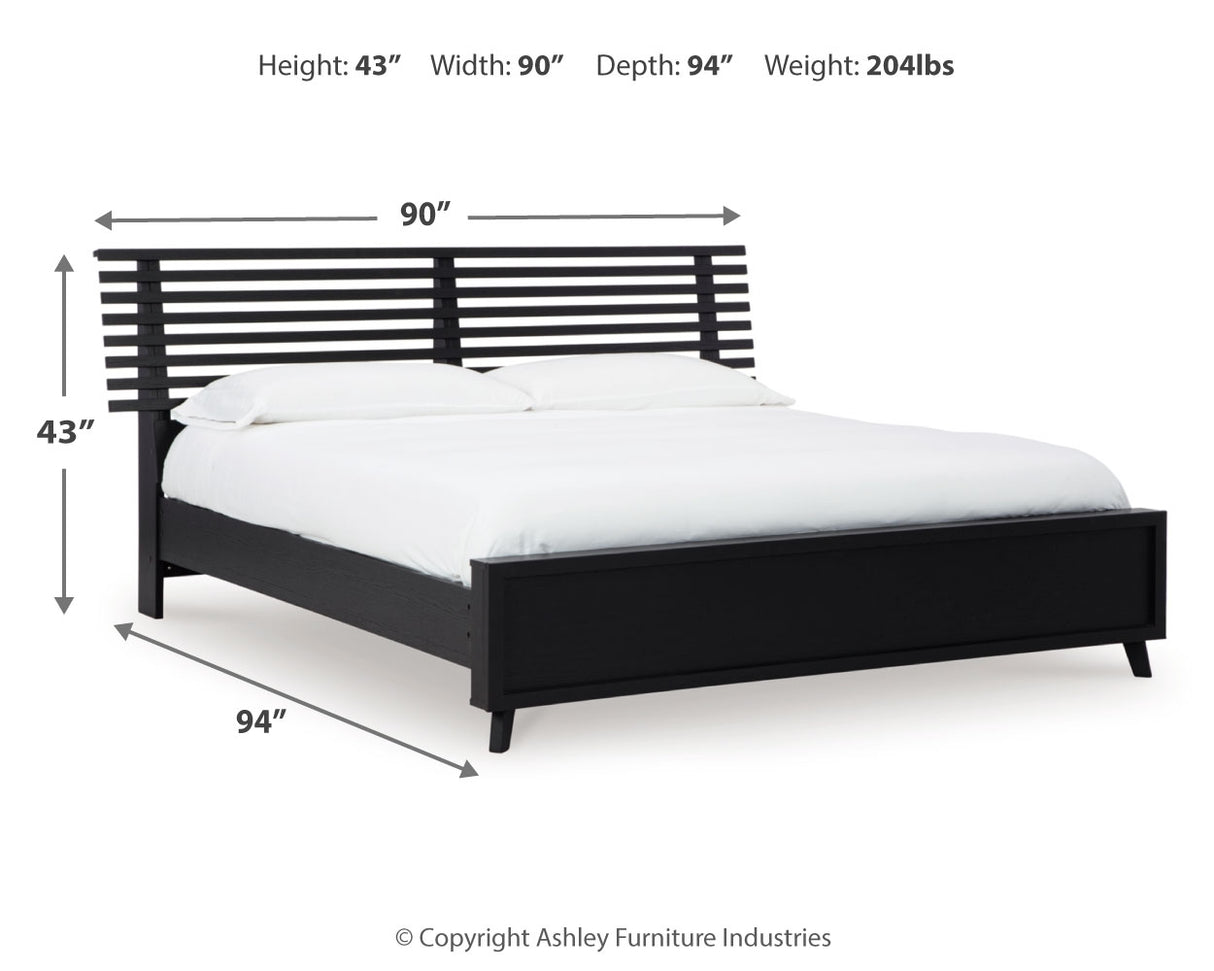 Danziar King Panel Bed with Mirrored Dresser and Nightstand in Black from Ashley - Luna Furniture