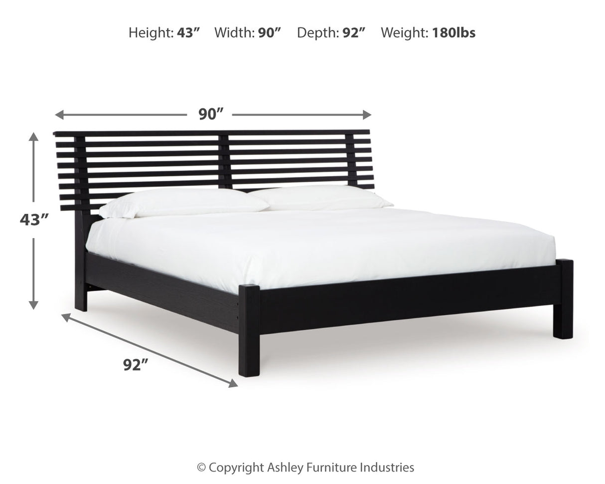 Danziar King Panel Bed with Mirrored Dresser, Chest and 2 Nightstands in Black from Ashley - Luna Furniture