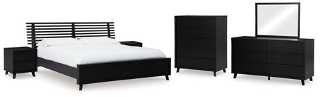 Danziar King Panel Bed with Mirrored Dresser, Chest and 2 Nightstands in Black from Ashley - Luna Furniture