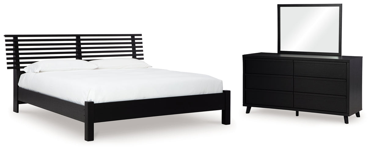 Danziar Queen Panel Bed with Mirrored Dresser in Black - PKG015877