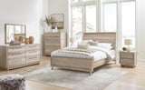 Hasbrick Queen Panel Bed with Mirrored Dresser, Chest and 2 Nightstands in Tan from Ashley - Luna Furniture