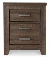 Juararo California King Panel Bed with Mirrored Dresser, Chest and 2 Nightstands in Dark Brown - PKG004058