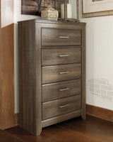 Juararo King Panel Bed with Mirrored Dresser, Chest and Nightstand in Dark Brown - PKG004073