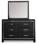 Kaydell King Upholstered Panel Bed with Mirrored Dresser and Chest in Black - PKG014230