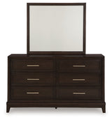 Neymorton California King Upholstered Panel Bed with Mirrored Dresser and Chest in Dark Grayish Brown from Ashley - Luna Furniture