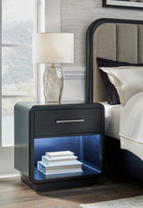 Rowanbeck Queen Upholstered Panel Bed with Mirrored Dresser, Chest and Nightstand in Gray/Black - PKG018795